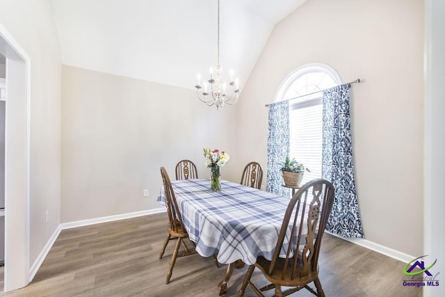 546 Grove Ln, Kathleen, GA 31047 - dining area featuring a chandelier, wood finished floors, and lofted ceiling