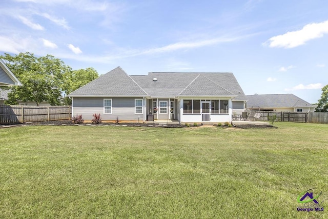 546 Grove Ln, Kathleen, GA 31047 - rear view of house featuring a sunroom, a fenced backyard, a patio area, and a shingled roof