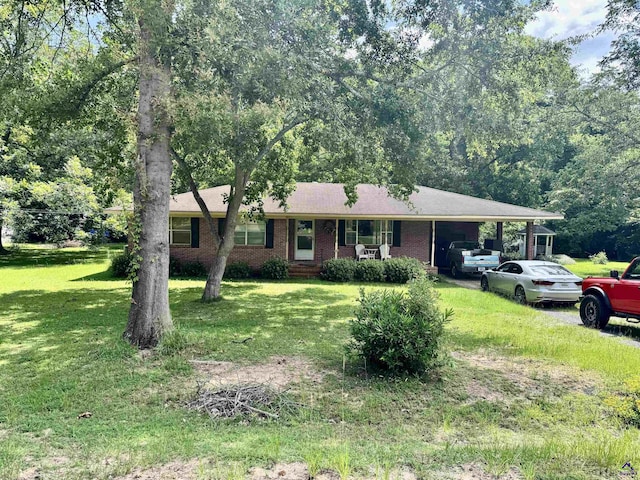 304 Mcwhorter St, Unadilla, GA 31091 - ranch-style house with an attached carport, a front lawn, and brick siding
