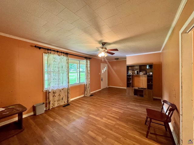 304 Mcwhorter St, Unadilla, GA 31091 - unfurnished living room with ornamental molding, ceiling fan, and wood finished floors