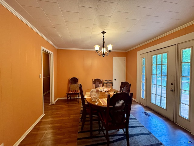 304 Mcwhorter St, Unadilla, GA 31091 - dining space with crown molding, healthy amount of natural light, a chandelier, and dark wood-style flooring