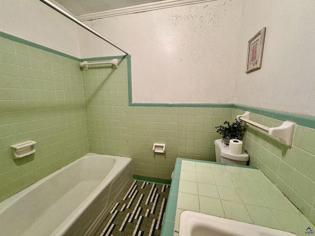 304 Mcwhorter St, Unadilla, GA 31091 - bathroom featuring tile walls, wainscoting, and tile patterned flooring