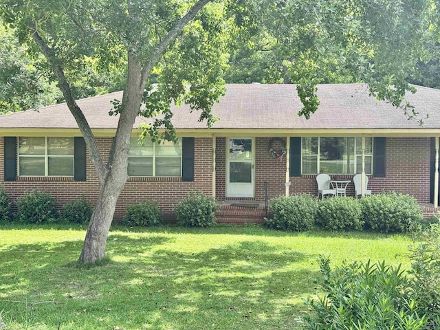 304 Mcwhorter St, Unadilla, GA 31091 - single story home featuring a front lawn, brick siding, and roof with shingles