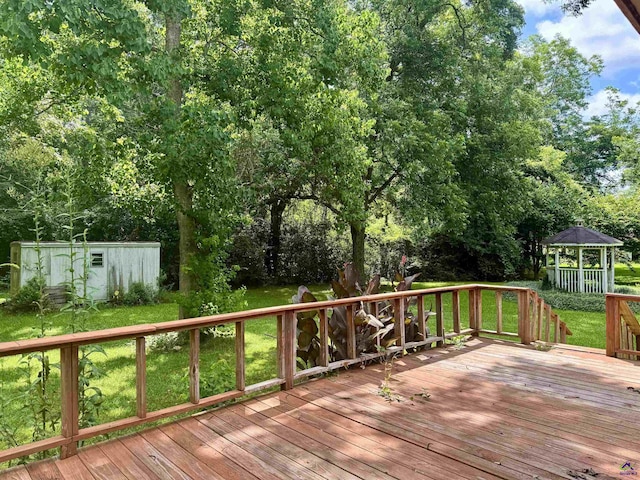304 Mcwhorter St, Unadilla, GA 31091 - wooden terrace featuring a lawn, view of scattered trees, a storage unit, and a gazebo