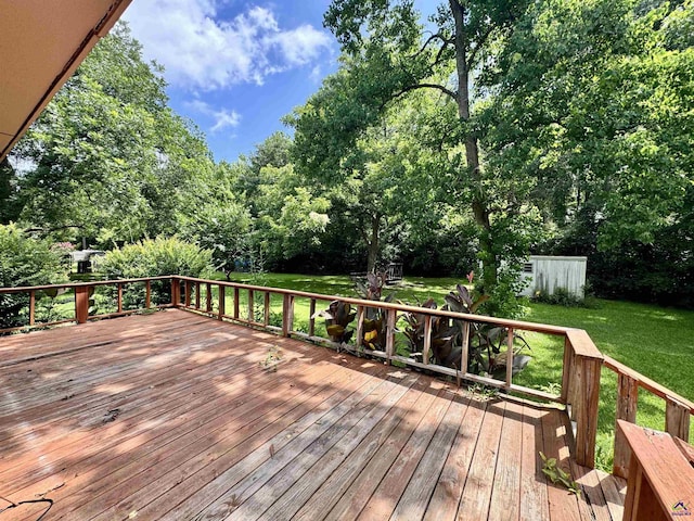 304 Mcwhorter St, Unadilla, GA 31091 - wooden terrace featuring a lawn, view of wooded area, and a shed