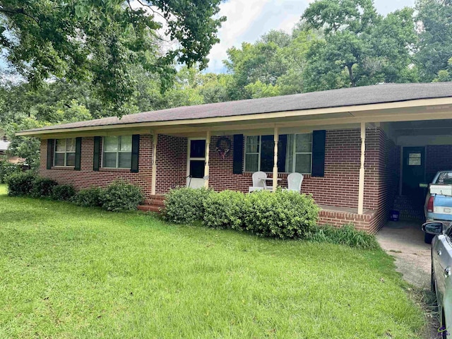 304 Mcwhorter St, Unadilla, GA 31091 - single story home featuring a front yard, brick siding, and an attached carport