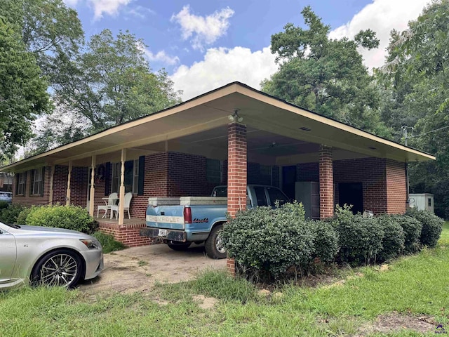 304 Mcwhorter St, Unadilla, GA 31091 - view of side of home with brick siding and a carport