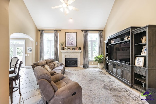 109 Black Oak Ct, Byron, GA 31008 - living area featuring arched walkways, high vaulted ceiling, light tile patterned floors, ceiling fan, and healthy amount of natural light