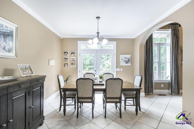 109 Black Oak Ct, Byron, GA 31008 - dining area with arched walkways, ornamental molding, a chandelier, light tile patterned flooring, and french doors