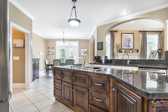 109 Black Oak Ct, Byron, GA 31008 - kitchen with stainless steel appliances, arched walkways, ornamental molding, hanging light fixtures, and french doors