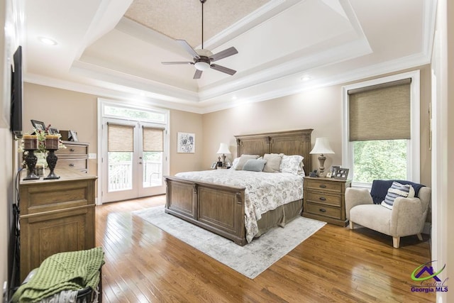 109 Black Oak Ct, Byron, GA 31008 - bedroom featuring a tray ceiling, access to exterior, multiple windows, hardwood / wood-style floors, and crown molding