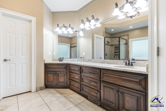 109 Black Oak Ct, Byron, GA 31008 - full bathroom featuring a chandelier, tile patterned floors, a shower stall, and double vanity