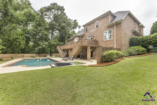 109 Black Oak Ct, Byron, GA 31008 - rear view of house with stairway, a wooden deck, brick siding, a fenced backyard, and a patio