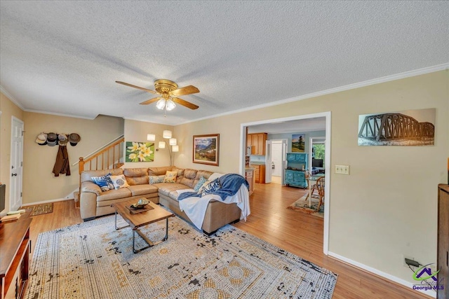 574 Shadow Moss Dr, Macon, GA 31204 - living room featuring stairway, light wood-style floors, a ceiling fan, a textured ceiling, and crown molding