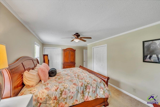 574 Shadow Moss Dr, Macon, GA 31204 - bedroom featuring two closets, ornamental molding, light colored carpet, a textured ceiling, and ceiling fan