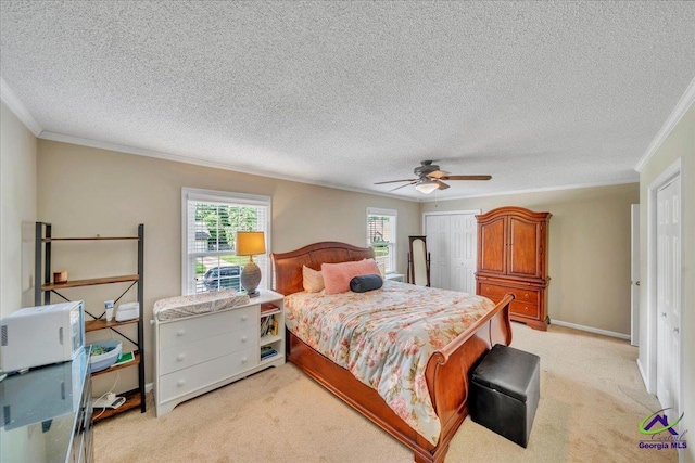 574 Shadow Moss Dr, Macon, GA 31204 - bedroom featuring ornamental molding, a closet, light carpet, a textured ceiling, and ceiling fan