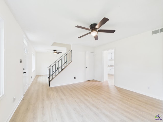 752 S Forest Lake Dr, Macon, GA 31210 - unfurnished living room with ceiling fan, light wood finished floors, and stairs