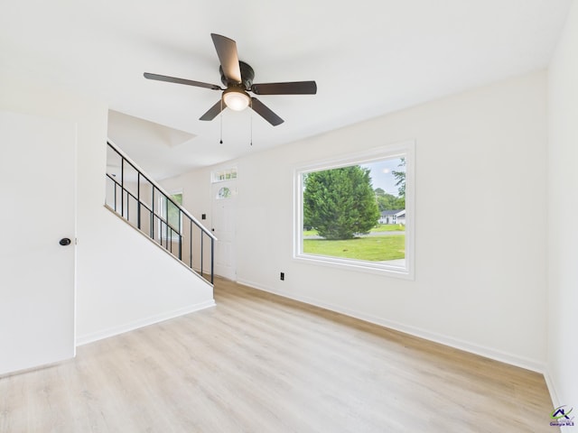 752 S Forest Lake Dr, Macon, GA 31210 - unfurnished living room with wood finished floors, a ceiling fan, and stairway