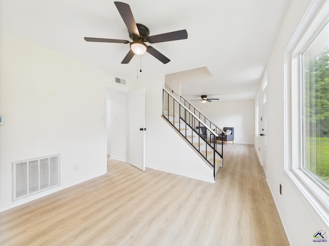 752 S Forest Lake Dr, Macon, GA 31210 - unfurnished living room with ceiling fan, stairway, light wood-style floors, and healthy amount of natural light