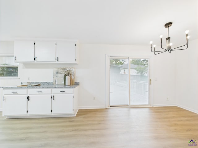 752 S Forest Lake Dr, Macon, GA 31210 - unfurnished dining area with a chandelier and light wood-style floors