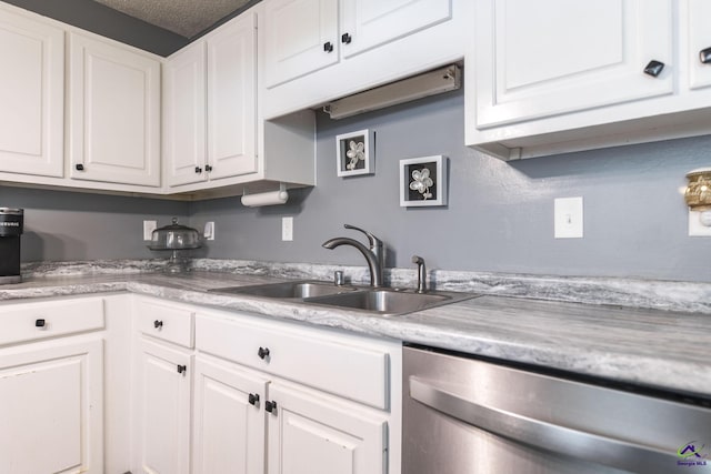 3560 S Lawrence Dr, Macon, GA 31216 - kitchen featuring dishwasher, light countertops, white cabinetry, and a textured ceiling