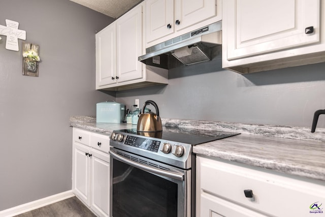 3560 S Lawrence Dr, Macon, GA 31216 - kitchen featuring stainless steel range with electric cooktop, under cabinet range hood, white cabinetry, and dark wood-type flooring