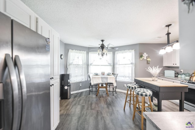 3560 S Lawrence Dr, Macon, GA 31216 - kitchen featuring stainless steel appliances, white cabinets, a textured ceiling, dark wood-type flooring, and light countertops