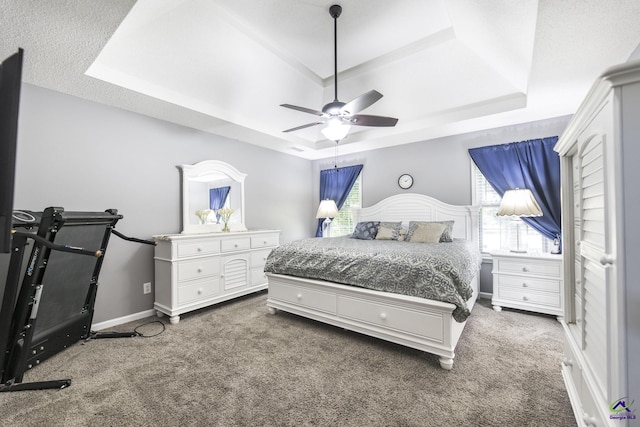 3560 S Lawrence Dr, Macon, GA 31216 - carpeted bedroom with a tray ceiling and a ceiling fan