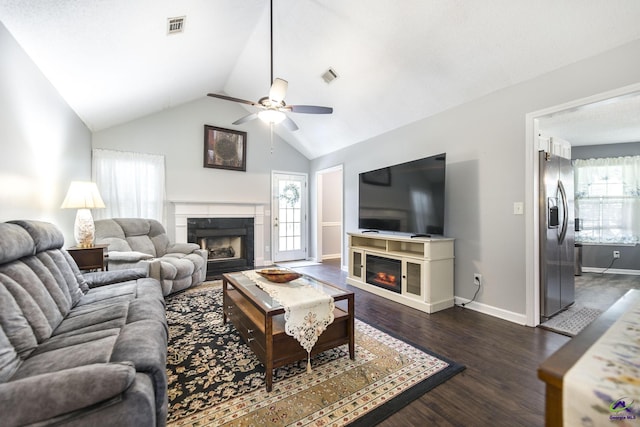 3560 S Lawrence Dr, Macon, GA 31216 - living area featuring a glass covered fireplace, a ceiling fan, dark wood-style flooring, and high vaulted ceiling