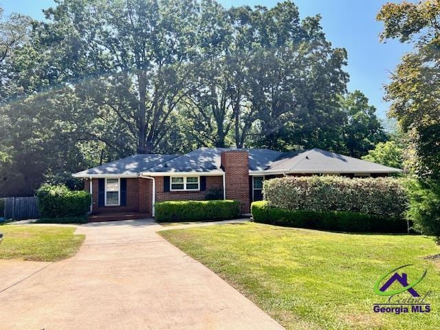 234 Briarcliff Rd, Warner Robins, GA 31088 - single story home with driveway, brick siding, and a chimney