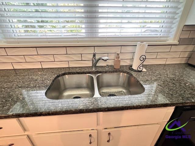 234 Briarcliff Rd, Warner Robins, GA 31088 - kitchen view of white cabinetry, backsplash, and dark stone countertops
