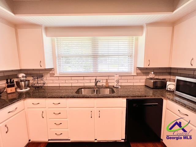 234 Briarcliff Rd, Warner Robins, GA 31088 - kitchen featuring stainless steel microwave, black dishwasher, white cabinetry, decorative backsplash, and dark stone counters
