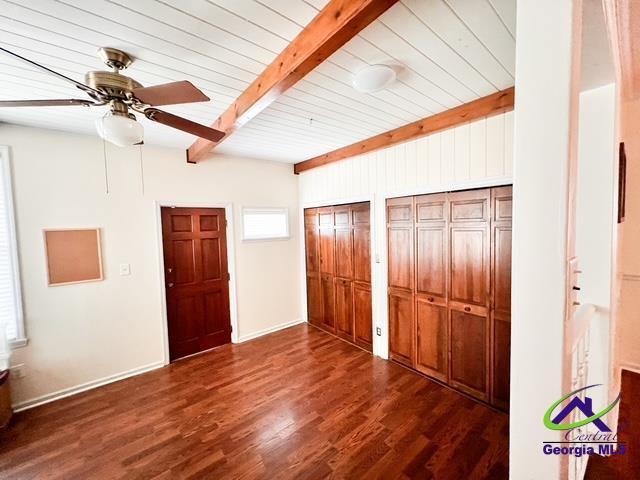 234 Briarcliff Rd, Warner Robins, GA 31088 - unfurnished bedroom featuring beamed ceiling, multiple closets, dark wood finished floors, and a ceiling fan