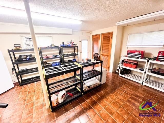234 Briarcliff Rd, Warner Robins, GA 31088 - miscellaneous room with a textured ceiling and tile patterned floors