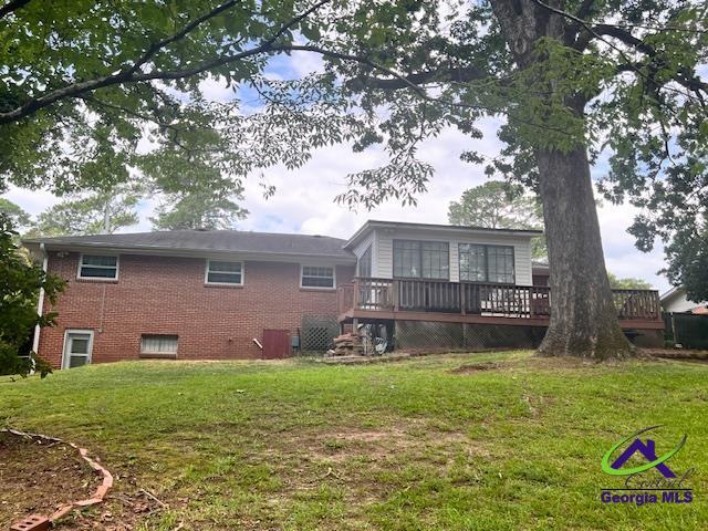 234 Briarcliff Rd, Warner Robins, GA 31088 - back of house with a wooden deck, brick siding, and a lawn