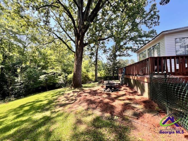 234 Briarcliff Rd, Warner Robins, GA 31088 - view of green lawn with a deck and a fire pit