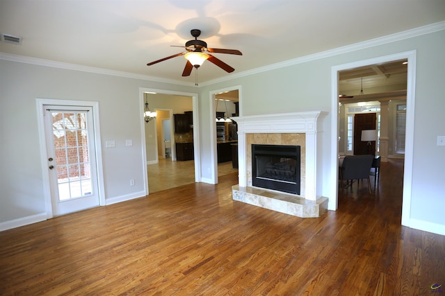 217 Wilsons Creek Bnd, Bonaire, GA 31005 - unfurnished living room with crown molding, a tile fireplace, ceiling fan, wood finished floors, and a chandelier