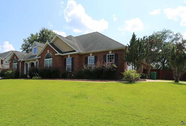 217 Wilsons Creek Bnd, Bonaire, GA 31005 - view of front of property with brick siding, a front lawn, and roof with shingles