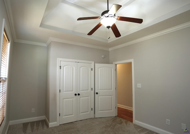 217 Wilsons Creek Bnd, Bonaire, GA 31005 - unfurnished bedroom featuring carpet floors, a tray ceiling, a closet, ornamental molding, and ceiling fan