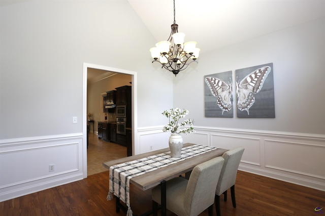 217 Wilsons Creek Bnd, Bonaire, GA 31005 - dining space with a chandelier, a decorative wall, wood finished floors, a wainscoted wall, and lofted ceiling
