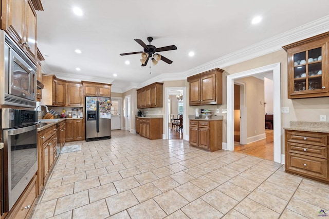 513 Litchfield, Macon, GA 31220 - kitchen featuring appliances with stainless steel finishes, a ceiling fan, brown cabinetry, light tile patterned flooring, and recessed lighting
