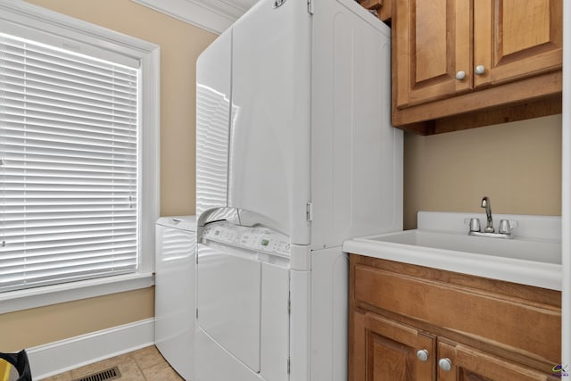 513 Litchfield, Macon, GA 31220 - laundry room with cabinet space, washing machine and clothes dryer, and light tile patterned floors