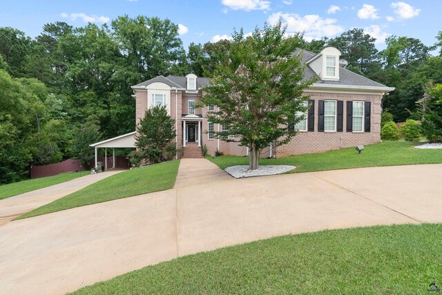 513 Litchfield, Macon, GA 31220 - view of front of house featuring brick siding, a front yard, concrete driveway, and a carport