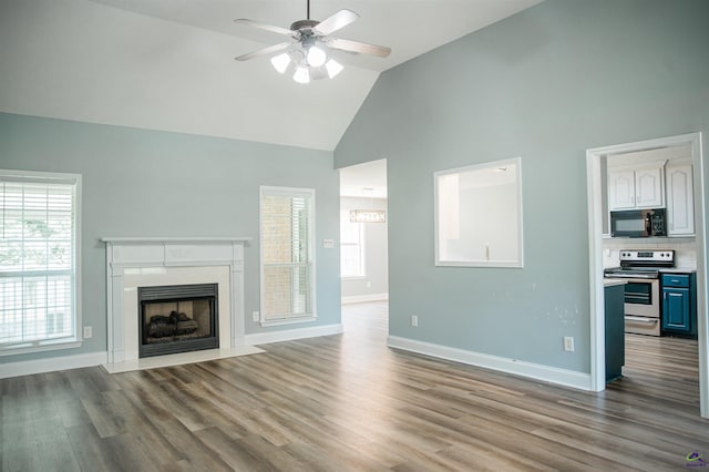 121 Spring Chase Cir, Kathleen, GA 31047 - unfurnished living room with high vaulted ceiling, a ceiling fan, wood finished floors, and plenty of natural light