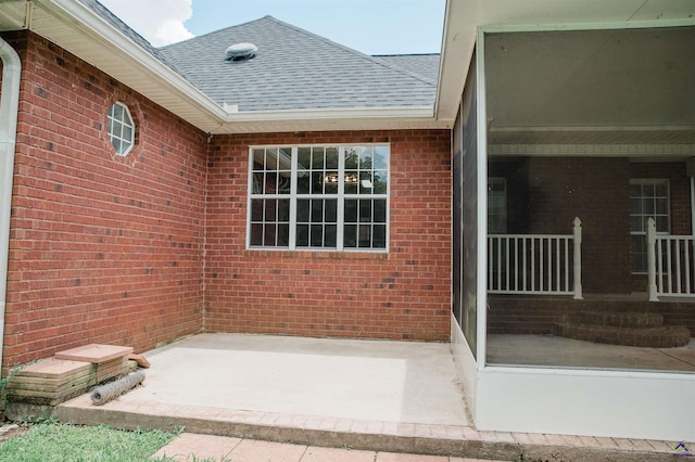 121 Spring Chase Cir, Kathleen, GA 31047 - view of exterior entry featuring a shingled roof, brick siding, and a patio area