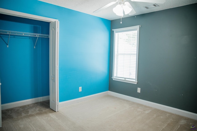 121 Spring Chase Cir, Kathleen, GA 31047 - unfurnished bedroom featuring carpet, multiple windows, a textured ceiling, and a closet