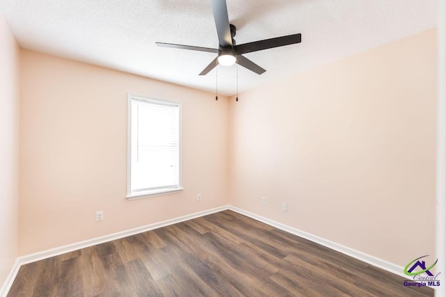 313 Strawbridge Ln, Bonaire, GA 31005 - spare room featuring ceiling fan and dark wood-type flooring