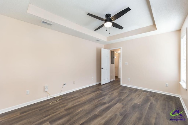 313 Strawbridge Ln, Bonaire, GA 31005 - unfurnished room with a tray ceiling, a ceiling fan, and dark wood-style floors