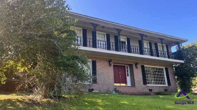 759 Mosby Ct, Macon, GA 32104 - view of front of house featuring a balcony, a front yard, crawl space, and brick siding