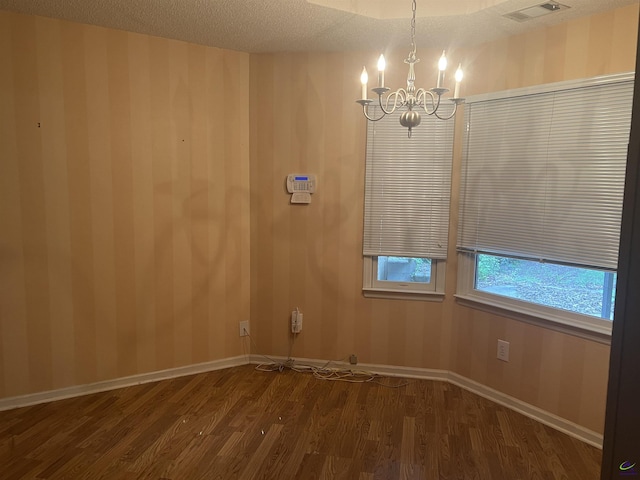 318 Pheasant Rdg, Warner Robins, GA 31088 - unfurnished room with a chandelier, dark wood-style flooring, and wallpapered walls